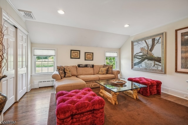 living room featuring a baseboard heating unit, lofted ceiling, and hardwood / wood-style floors