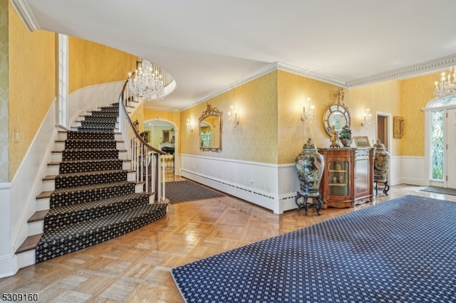 interior space with parquet floors, crown molding, and a chandelier