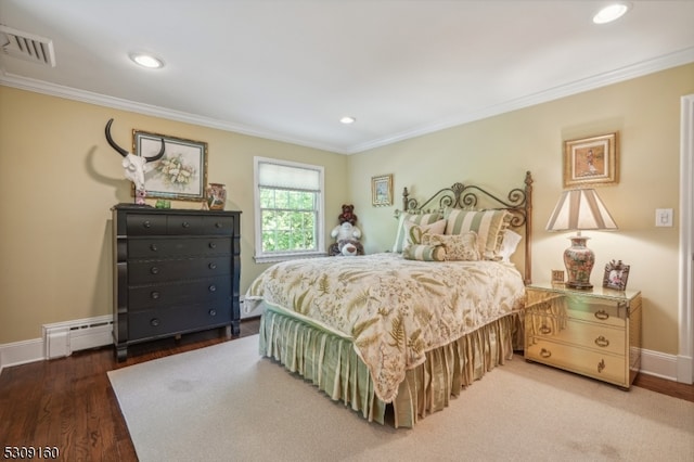 bedroom with hardwood / wood-style flooring, crown molding, and a baseboard radiator