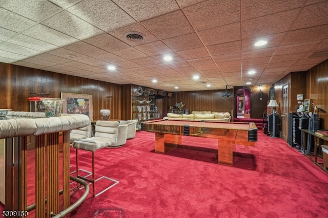 playroom with carpet, wood walls, pool table, and a paneled ceiling