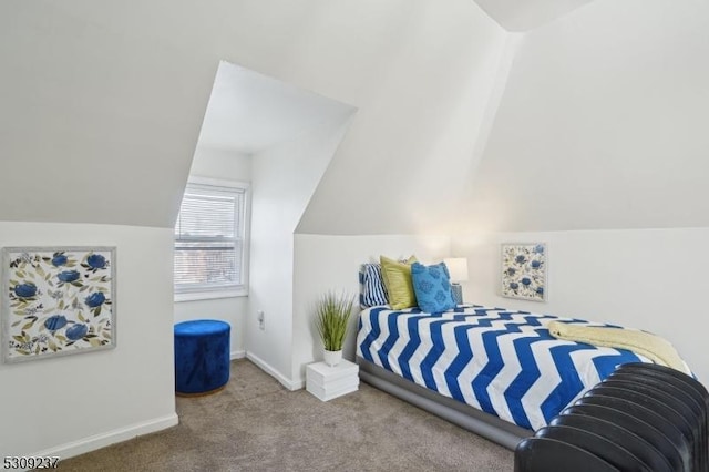 carpeted bedroom featuring baseboards and vaulted ceiling