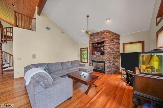 80 Rte 206, Chester Twp, NJ 07930 - living area with stairs, light wood finished floors, a stone fireplace, and high vaulted ceiling