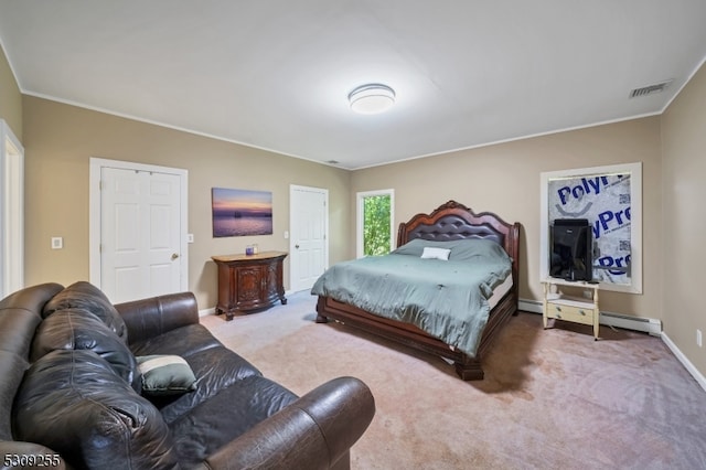 bedroom with a baseboard heating unit and carpet