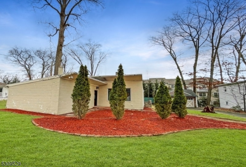 view of side of home featuring a lawn