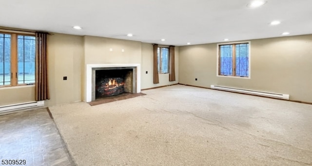 unfurnished living room with light colored carpet and baseboard heating