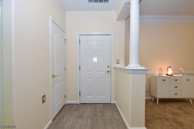 carpeted entrance foyer with ornate columns