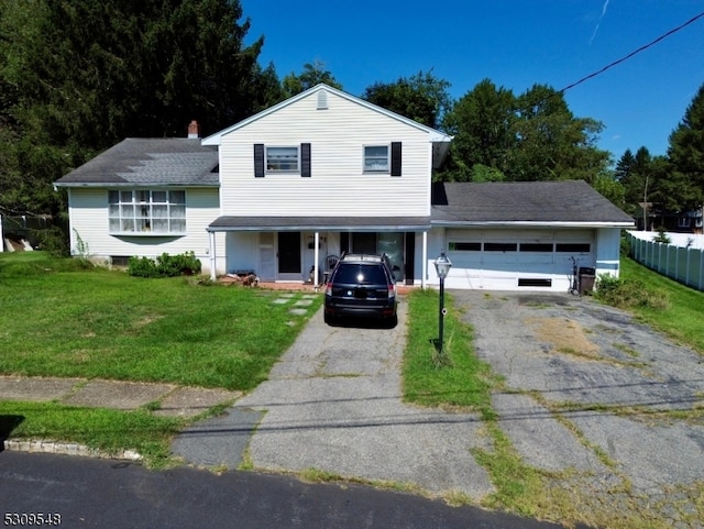 view of front of house with a front yard and a garage