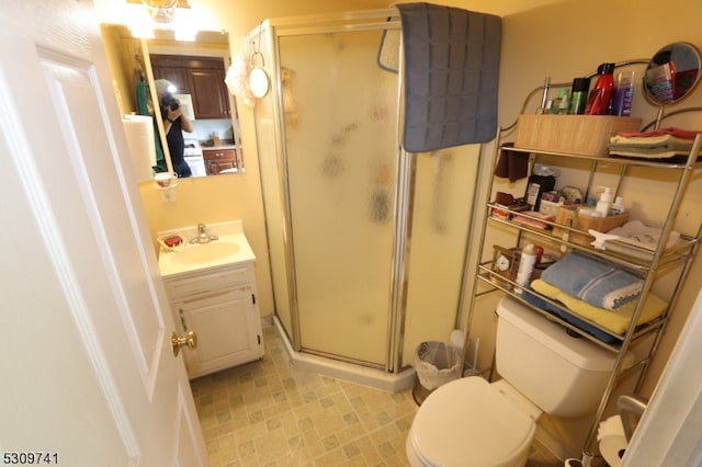 bathroom with vanity, toilet, and an enclosed shower