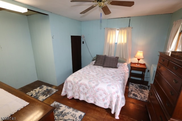 bedroom featuring ceiling fan and dark hardwood / wood-style floors