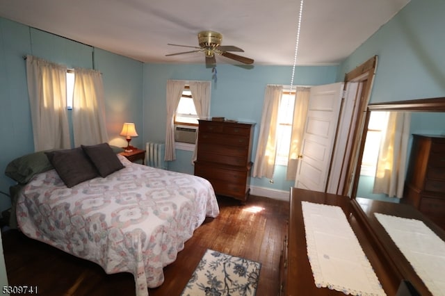 bedroom with dark wood-type flooring and radiator