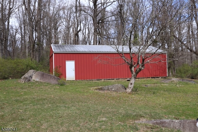 view of outbuilding with a lawn