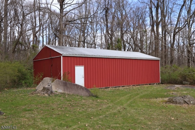 view of outdoor structure with a lawn