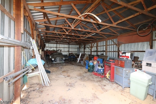 interior space featuring lofted ceiling and concrete flooring