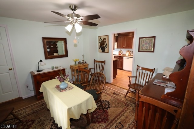 dining area with wood-type flooring and ceiling fan