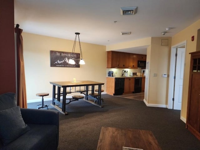 dining room with carpet floors, visible vents, and baseboards