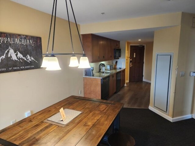 kitchen with black appliances, sink, decorative backsplash, and dark wood-type flooring