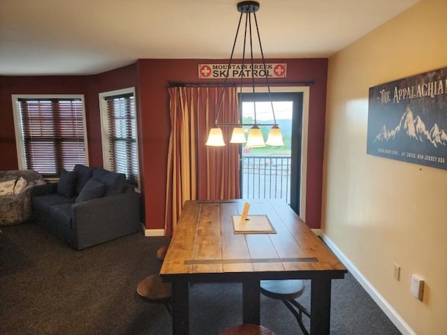 carpeted dining space with baseboards