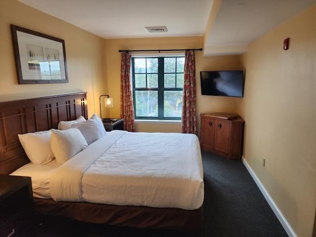 bedroom with carpet flooring, visible vents, and baseboards