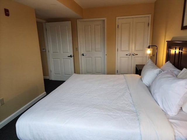 bedroom featuring a closet and baseboards