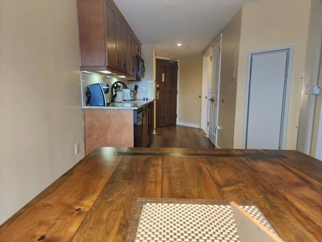 kitchen featuring dark wood-type flooring and tasteful backsplash