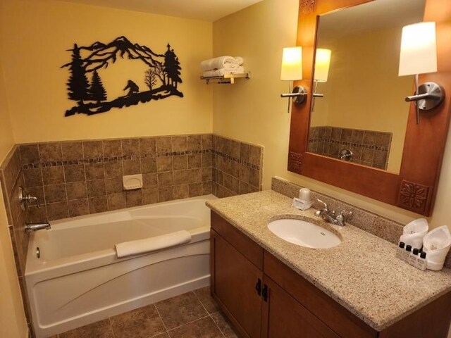 bathroom with vanity, a bathing tub, and tile patterned floors