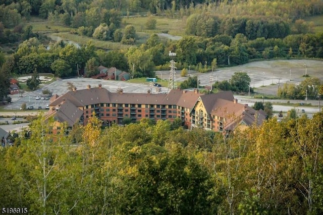 birds eye view of property with a forest view