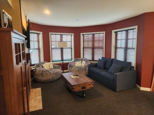 carpeted living room featuring baseboards