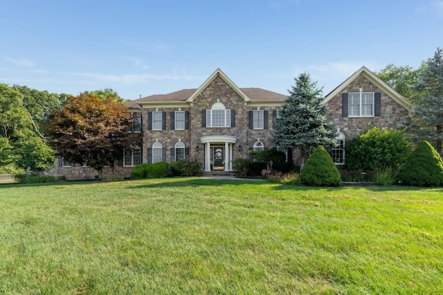 colonial inspired home with a front yard