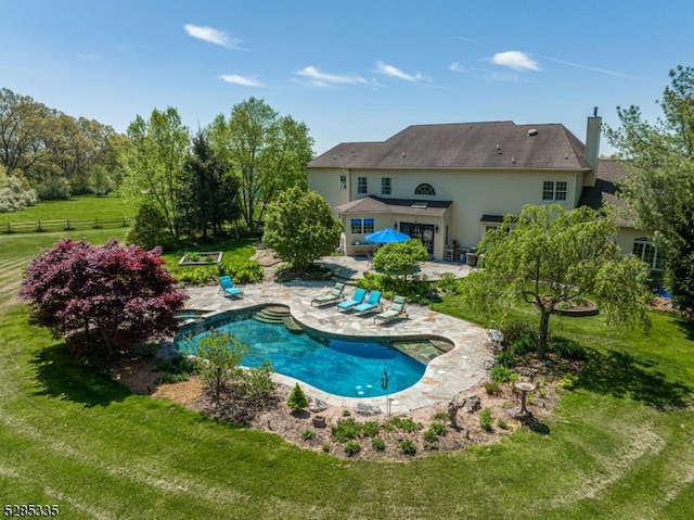 view of pool featuring a yard and a patio