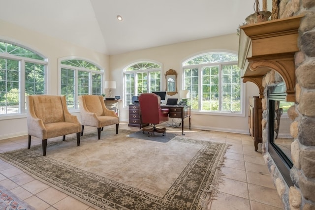 living area featuring light tile patterned floors, high vaulted ceiling, and a fireplace