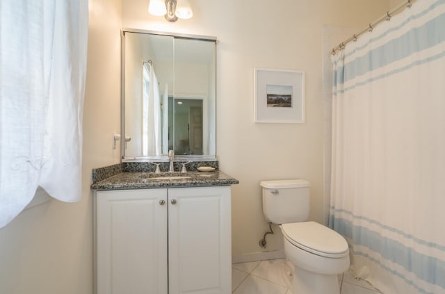 bathroom with vanity, toilet, a shower with curtain, and tile patterned floors