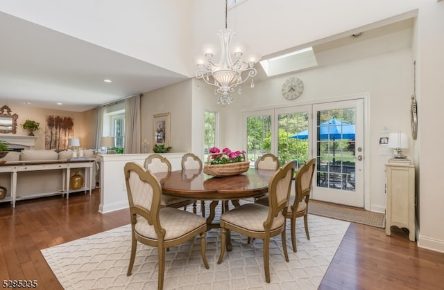 dining space with an inviting chandelier and hardwood / wood-style flooring