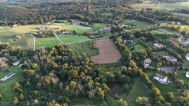 birds eye view of property with a rural view