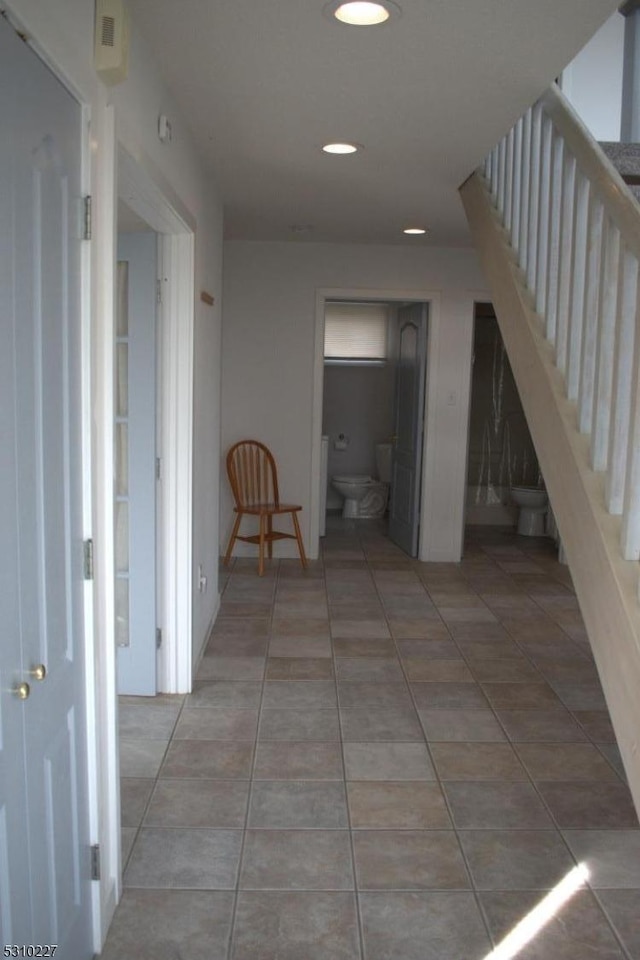 corridor with tile patterned flooring