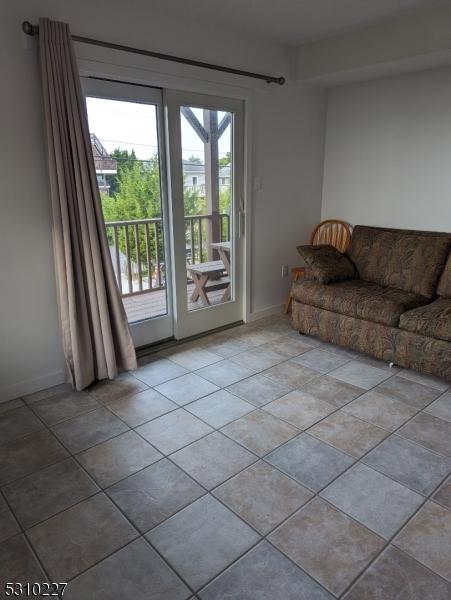 unfurnished living room featuring light tile patterned floors