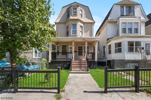 view of front facade with covered porch and a front yard