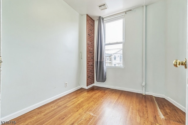 unfurnished room with light hardwood / wood-style floors