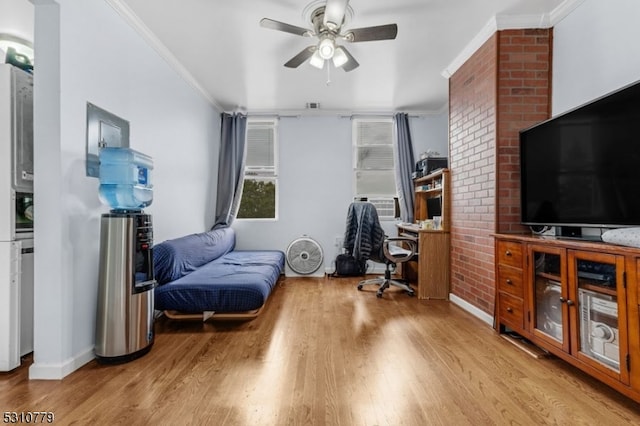 sitting room featuring light hardwood / wood-style flooring, ceiling fan, and crown molding