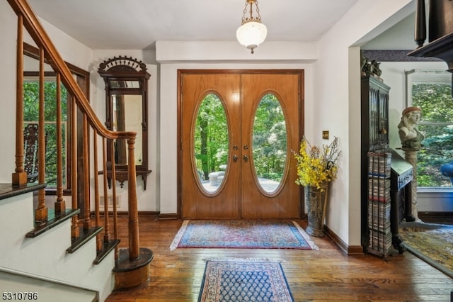 entrance foyer featuring plenty of natural light, french doors, and dark hardwood / wood-style flooring