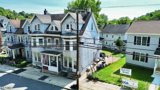 view of front of house featuring a balcony and a front yard