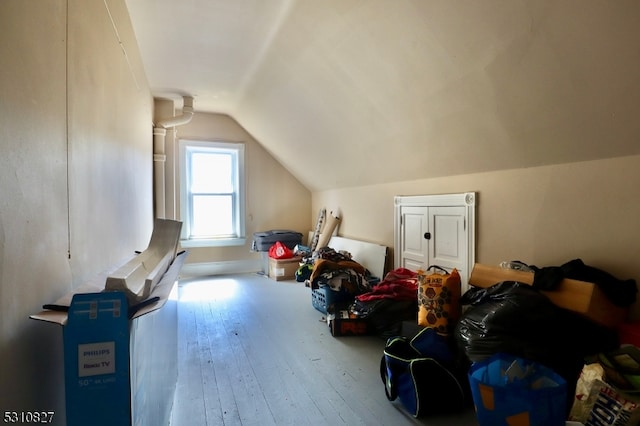 additional living space featuring hardwood / wood-style flooring and vaulted ceiling