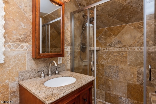 bathroom featuring vanity and an enclosed shower