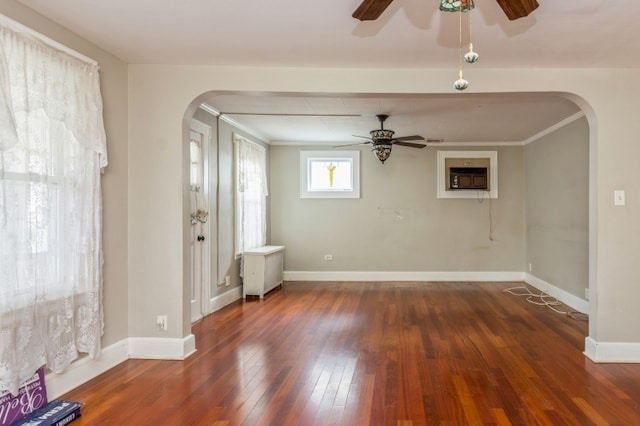 spare room featuring ceiling fan, dark hardwood / wood-style flooring, and crown molding