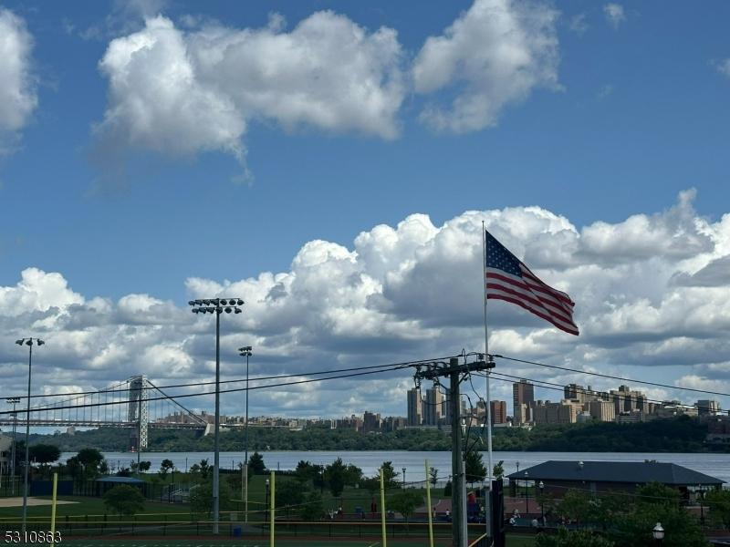 exterior space featuring a city view and a water view