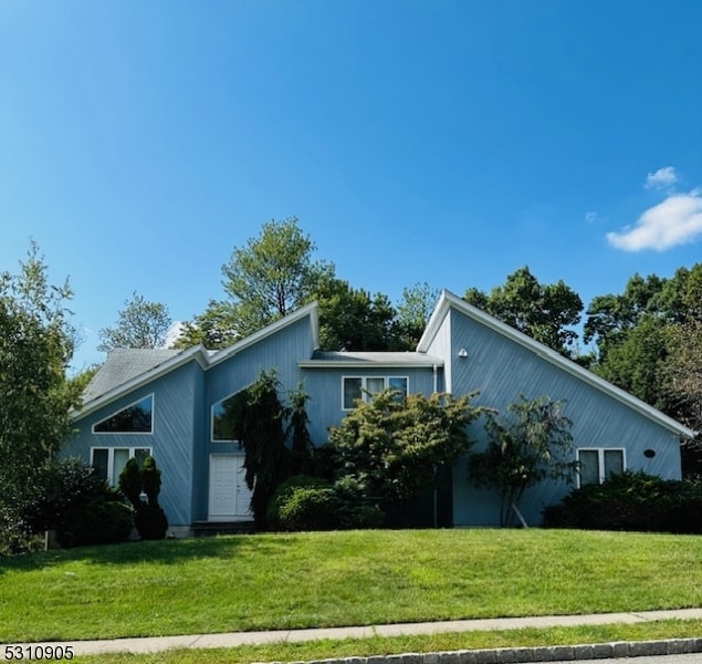 view of home's exterior with a garage and a lawn