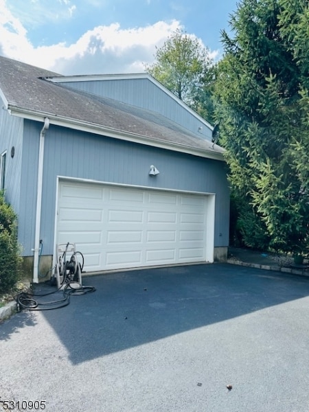 garage featuring wood walls