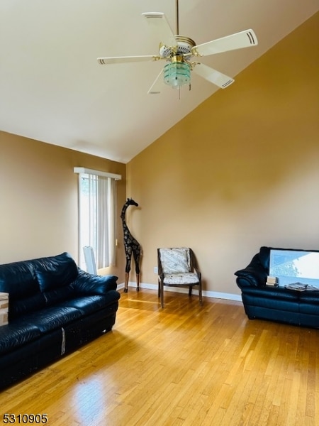 living room with light wood-type flooring, lofted ceiling, and ceiling fan