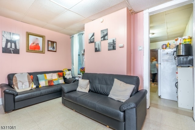 living room featuring a drop ceiling