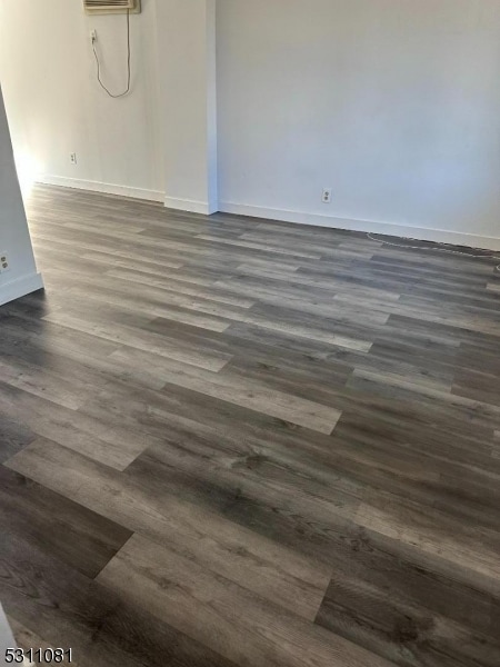 spare room with dark hardwood / wood-style floors