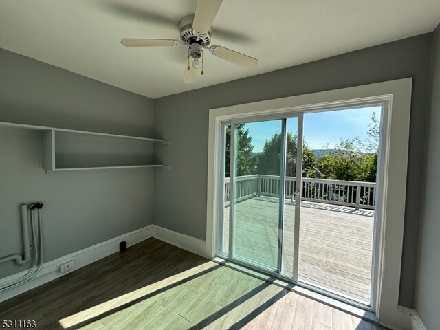 interior space with wood-type flooring and ceiling fan